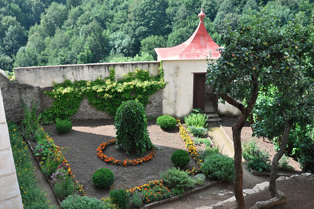 Herb garden below the first courtyard with apple tree and weeping mulberry