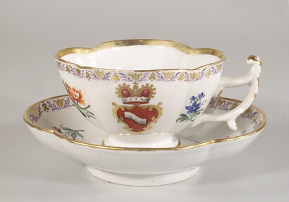 Cup and saucer with painted heraldic motif